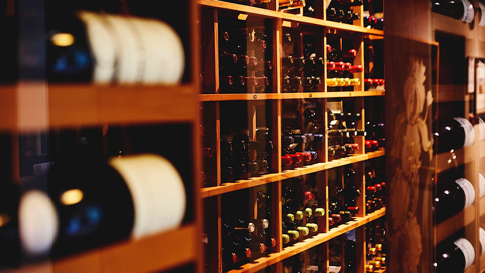 Bottles on wood shelves in the cellar of Opus Restaurant on Prince Arthur in Canada